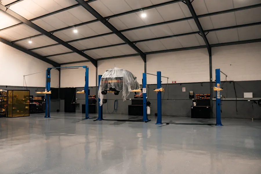 The workshop floor with blue two-post lifts